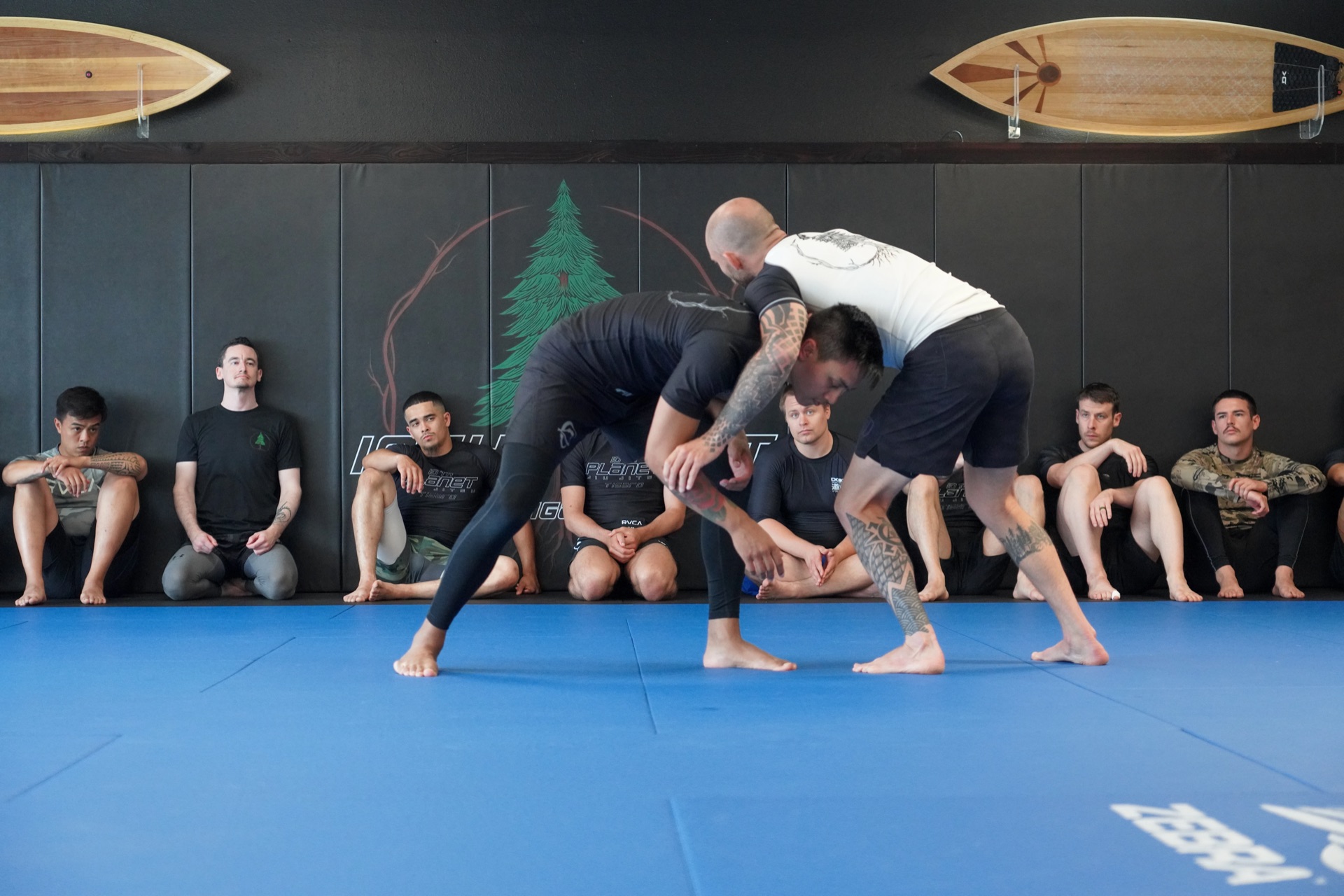10th Planet Tigard — instructor demonstrating a takedown while students watch